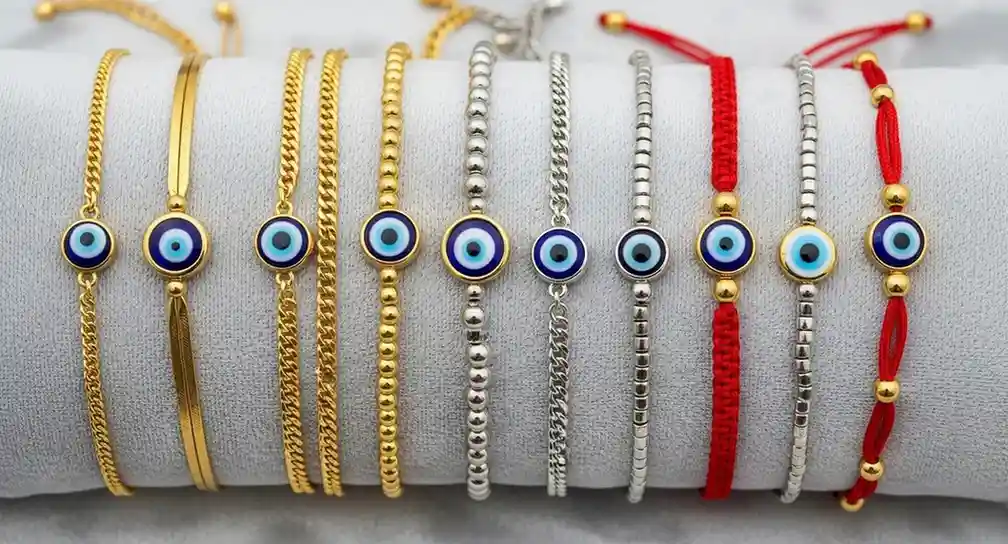 A display of gold, silver, beaded, and red string evil eye bracelets
